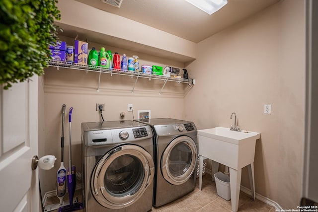 10715 Palomino, San Antonio, TX 78254 - laundry room with washer and dryer, light tile patterned floors, and baseboards
