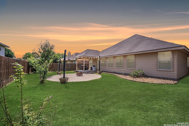 10715 Palomino, San Antonio, TX 78254 - back of property at dusk featuring a patio, a fire pit, and a shingled roof