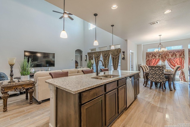 2564 Ayers, Seguin, TX 78155 - kitchen featuring a sink, arched walkways, stainless steel dishwasher, a chandelier, and light wood-style floors