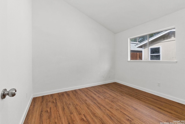 10707 Musket, San Antonio, TX 78224 - empty room featuring lofted ceiling, wood finished floors, and baseboards