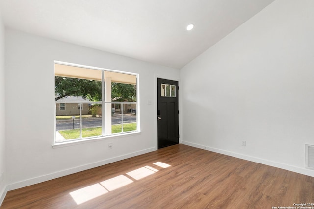10707 Musket, San Antonio, TX 78224 - unfurnished room with wood finished floors, baseboards, vaulted ceiling, and recessed lighting