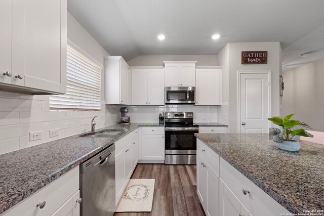 6038 Ballast Trl, New Braunfels, TX 78132 - kitchen with stainless steel appliances, a sink, white cabinets, stone countertops, and dark wood-style floors