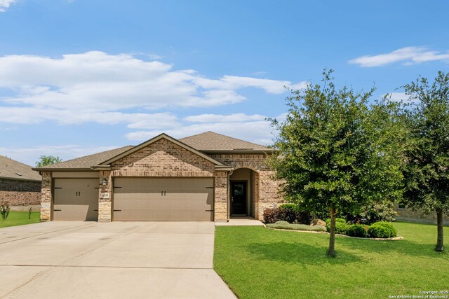 6038 Ballast Trl, New Braunfels, TX 78132 - view of front facade with an attached garage, concrete driveway, a front lawn, brick siding, and roof with shingles