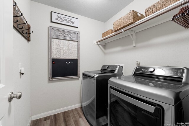 6038 Ballast Trl, New Braunfels, TX 78132 - clothes washing area featuring washer and clothes dryer, wood finished floors, and baseboards