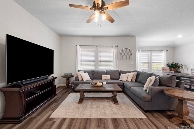 6038 Ballast Trl, New Braunfels, TX 78132 - living room with dark wood finished floors, ceiling fan, and recessed lighting