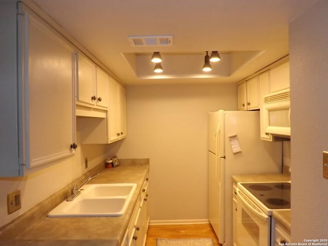 2300 Nacogdoches Unit 210C, San Antonio, TX 78209 - kitchen featuring a sink, white electric range oven, white cabinetry, light countertops, and light wood finished floors