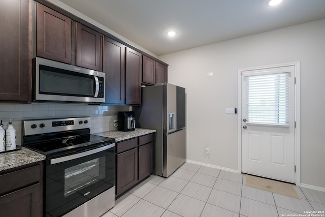 7731 Chatham, San Antonio, TX 78218 - kitchen featuring stainless steel appliances, dark brown cabinets, backsplash, baseboards, and light stone counters