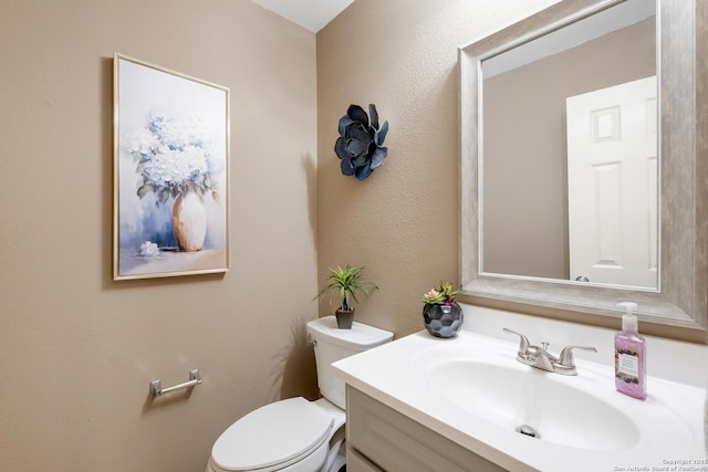 half bath with vanity and toilet