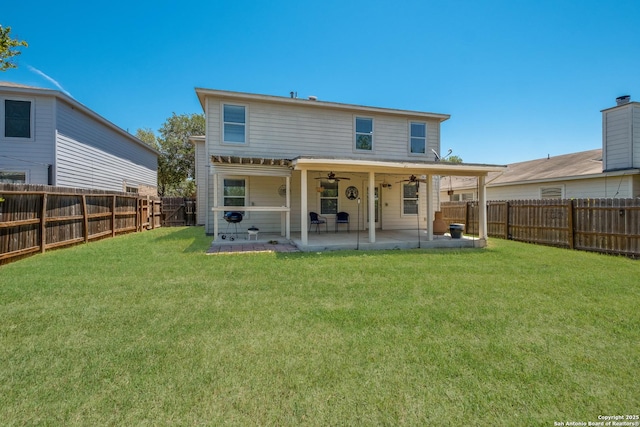 rear view of property with a patio area and ceiling fan