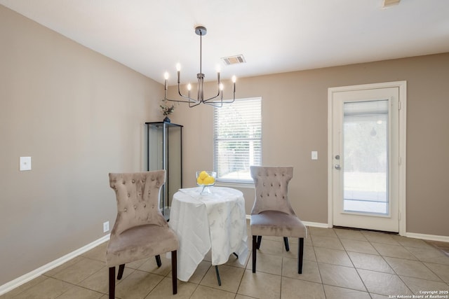 dining room with a chandelier, baseboards, and light tile patterned floors
