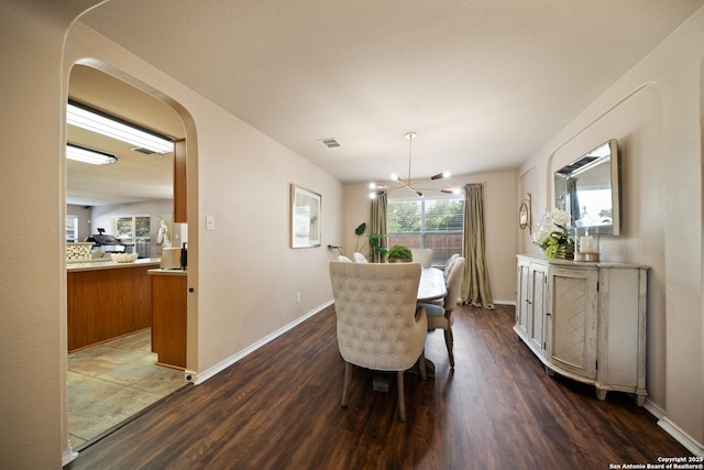 15206 Redbird Mnr, San Antonio, TX 78253 - dining room featuring a chandelier, arched walkways, dark wood-type flooring, and baseboards