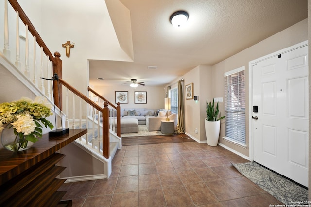 15206 Redbird Mnr, San Antonio, TX 78253 - entrance foyer featuring stairway, ceiling fan, dark tile patterned flooring, and baseboards