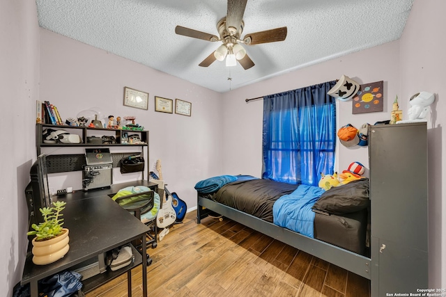 8239 Glen Lark, San Antonio, TX 78239 - bedroom featuring wood finished floors, a textured ceiling, a ceiling fan, and baseboards