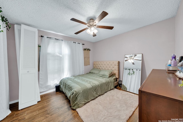 8239 Glen Lark, San Antonio, TX 78239 - bedroom featuring wood finished floors, a textured ceiling, ceiling fan, and baseboards