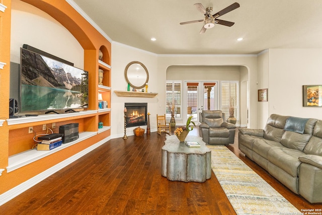 28914 Gracies Sky, San Antonio, TX 78260 - living area featuring ceiling fan, wood-type flooring, a glass covered fireplace, built in shelves, and crown molding