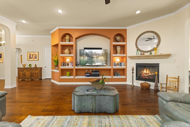 28914 Gracies Sky, San Antonio, TX 78260 - living room featuring arched walkways, wood finished floors, a fireplace, ornamental molding, and built in shelves