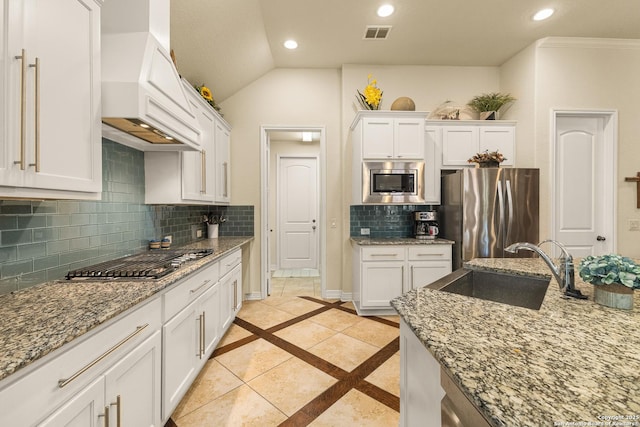 28914 Gracies Sky, San Antonio, TX 78260 - kitchen featuring appliances with stainless steel finishes, a sink, custom range hood, inlaid floor details, and white cabinets