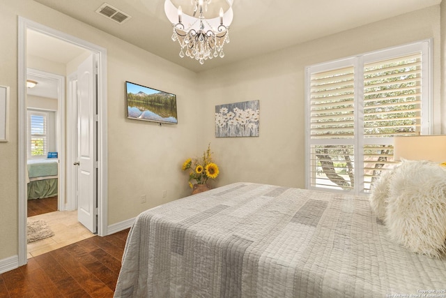 28914 Gracies Sky, San Antonio, TX 78260 - bedroom featuring wood finished floors, a chandelier, and baseboards