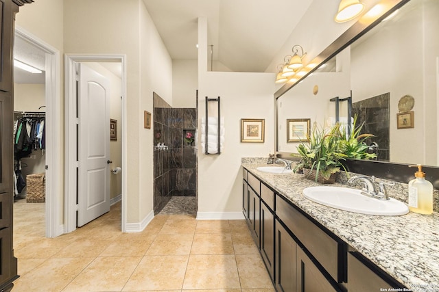 28914 Gracies Sky, San Antonio, TX 78260 - bathroom with walk in shower, double vanity, baseboards, tile patterned flooring, and lofted ceiling