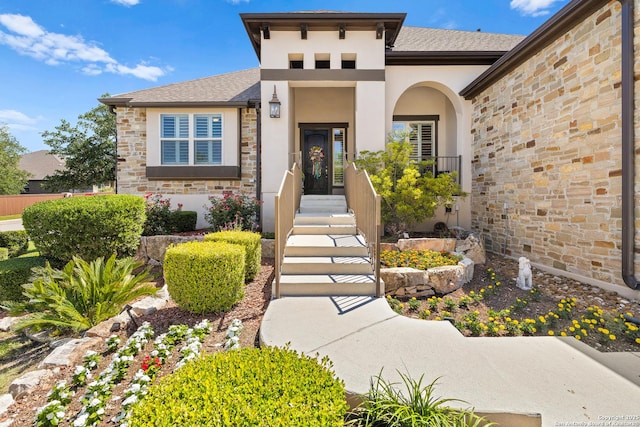 28914 Gracies Sky, San Antonio, TX 78260 - view of exterior entry with stucco siding, stone siding, and roof with shingles