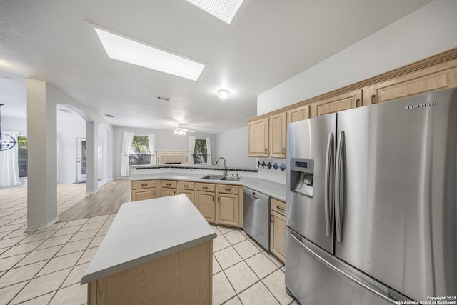 4726 Shavano Bark, San Antonio, TX 78230 - kitchen featuring appliances with stainless steel finishes, light brown cabinets, a sink, a peninsula, and light tile patterned floors