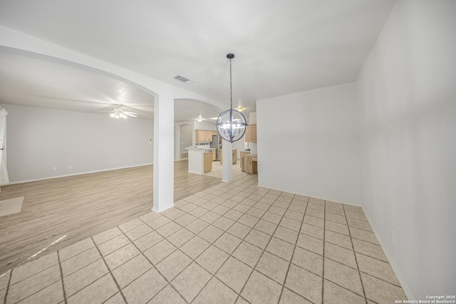 4726 Shavano Bark, San Antonio, TX 78230 - empty room with a chandelier, a ceiling fan, arched walkways, and baseboards