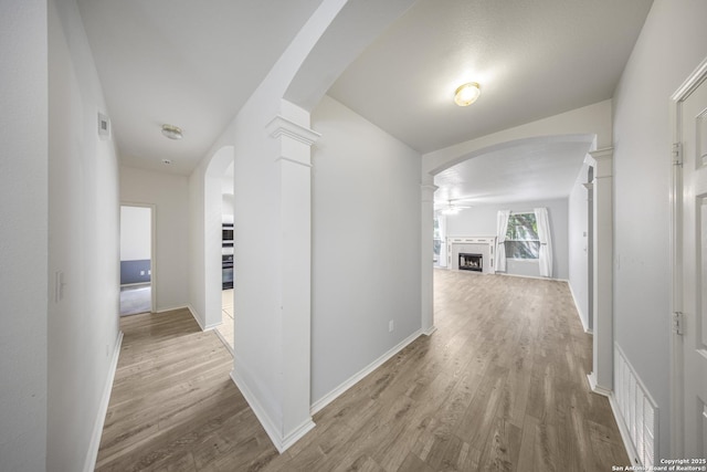 4726 Shavano Bark, San Antonio, TX 78230 - hall with arched walkways, wood finished floors, and baseboards