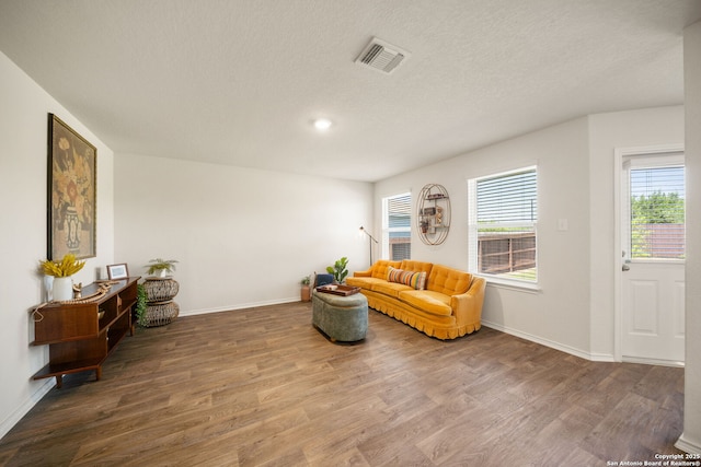 9827 Western Sedge, San Antonio, TX 78254 - sitting room featuring wood finished floors, healthy amount of natural light, baseboards, and a textured ceiling