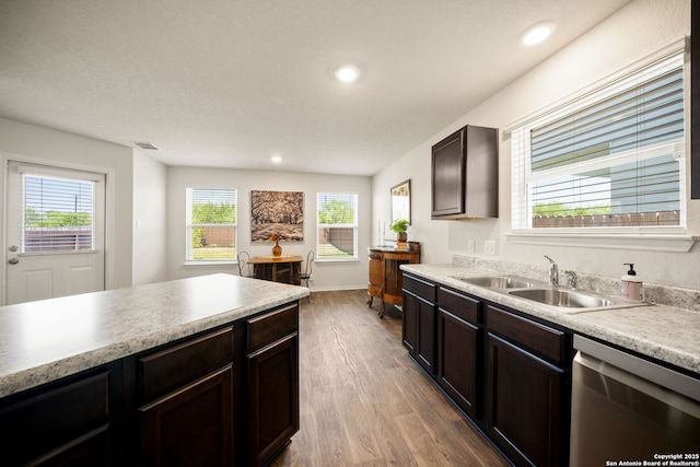 9827 Western Sedge, San Antonio, TX 78254 - kitchen featuring stainless steel dishwasher, a sink, wood finished floors, light countertops, and recessed lighting