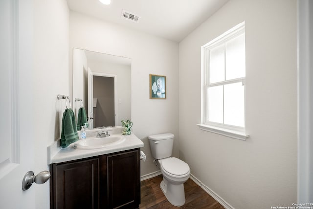 9827 Western Sedge, San Antonio, TX 78254 - half bath with toilet, vanity, wood finished floors, and baseboards