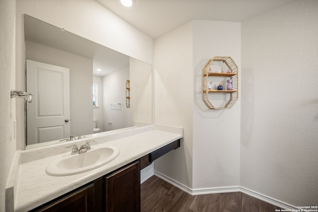 9827 Western Sedge, San Antonio, TX 78254 - bathroom with toilet, wood finished floors, baseboards, and vanity