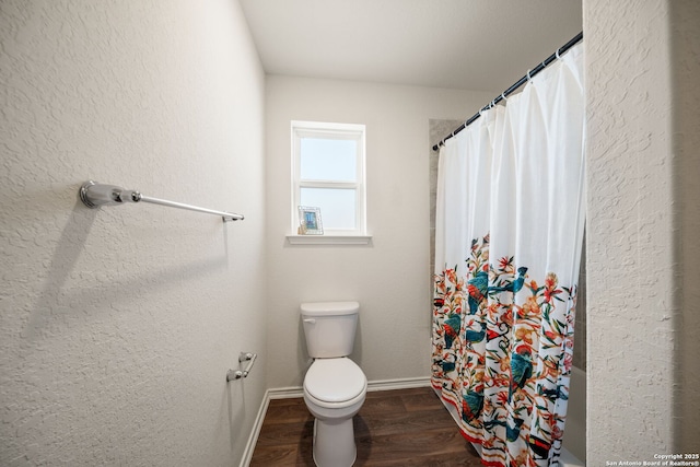 9827 Western Sedge, San Antonio, TX 78254 - full bathroom featuring baseboards, toilet, wood finished floors, and a shower with shower curtain