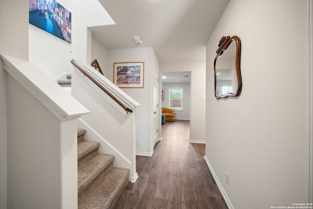 9827 Western Sedge, San Antonio, TX 78254 - hall featuring dark wood-style flooring, baseboards, and stairs