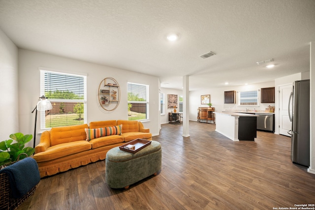 9827 Western Sedge, San Antonio, TX 78254 - living room with dark wood finished floors, recessed lighting, and a textured ceiling