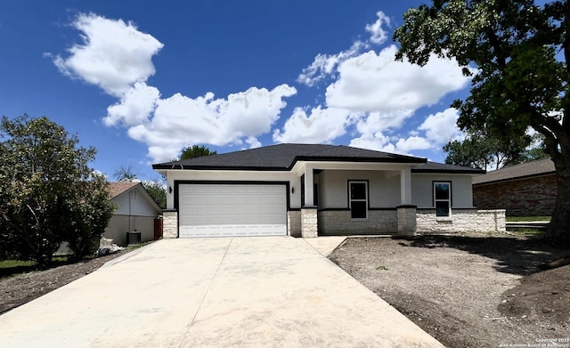 6427 Ridge Cir, San Antonio, TX 78233 - prairie-style home with stone siding, stucco siding, driveway, and a garage