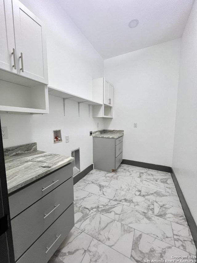 6427 Ridge Cir, San Antonio, TX 78233 - washroom with cabinet space, baseboards, light marble finish floors, and electric dryer hookup