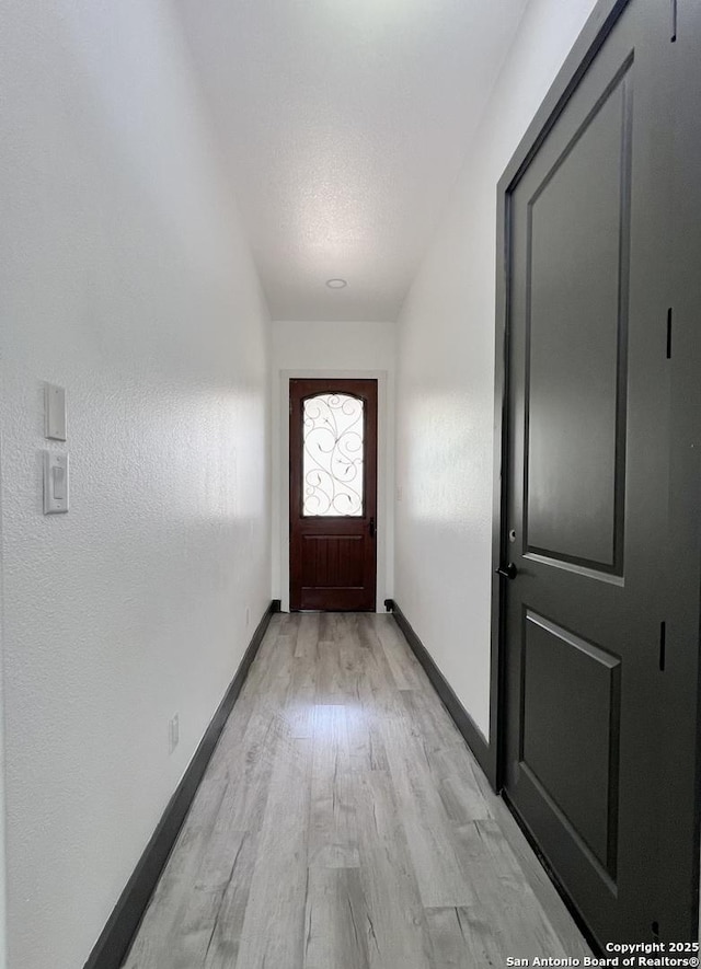 6427 Ridge Cir, San Antonio, TX 78233 - doorway featuring baseboards and light wood-type flooring