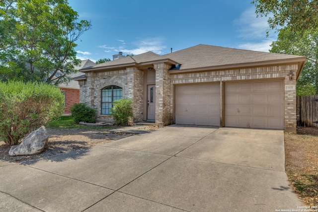 9419 Camino Venado, Helotes, TX 78023 - view of front of house featuring brick siding, an attached garage, concrete driveway, fence, and a chimney