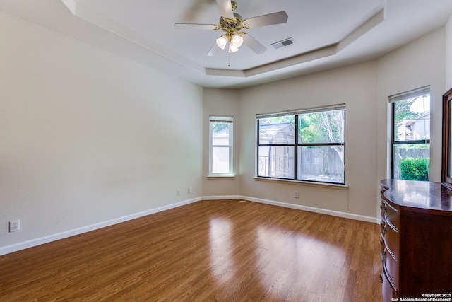 9419 Camino Venado, Helotes, TX 78023 - unfurnished room with wood finished floors, a raised ceiling, ceiling fan, and baseboards