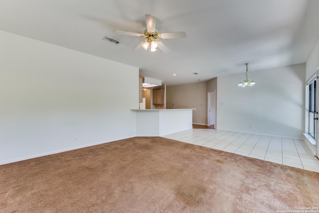 9419 Camino Venado, Helotes, TX 78023 - unfurnished living room with light carpet, light tile patterned floors, a chandelier, a ceiling fan, and baseboards