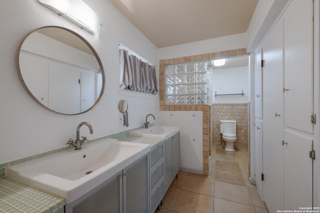 226 Carolwood Dr, Castle Hills, TX 78213 - full bathroom with tile patterned flooring, toilet, double vanity, and tile walls