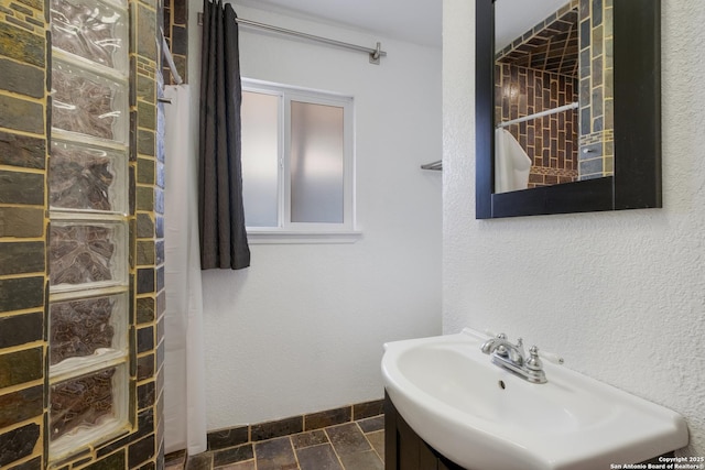 226 Carolwood Dr, Castle Hills, TX 78213 - full bathroom featuring a sink, walk in shower, and stone tile flooring
