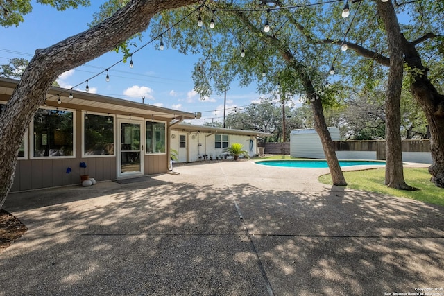 226 Carolwood Dr, Castle Hills, TX 78213 - view of swimming pool with fence, a patio, an outdoor structure, and a storage shed