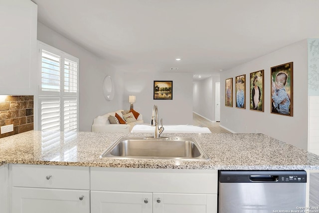 1919 Goldfinch, New Braunfels, TX 78130 - kitchen with stainless steel dishwasher, a sink, white cabinetry, and recessed lighting
