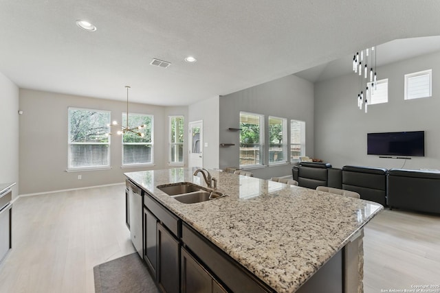 6739 Indian, San Antonio, TX 78253 - kitchen with a sink, light wood-style flooring, open floor plan, a chandelier, and recessed lighting