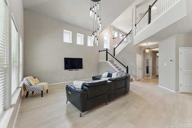 6739 Indian, San Antonio, TX 78253 - living area featuring a high ceiling, light wood-style floors, stairs, and baseboards