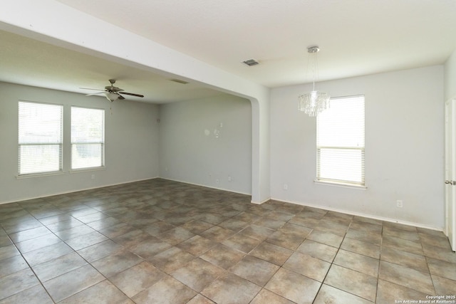 13131 Piper Sonoma, San Antonio, TX 78253 - empty room featuring a chandelier, ceiling fan, arched walkways, and tile patterned flooring