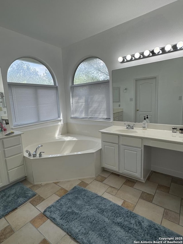 22722 Sabine, San Antonio, TX 78258 - full bathroom featuring vanity, a garden tub, and stone finish floors