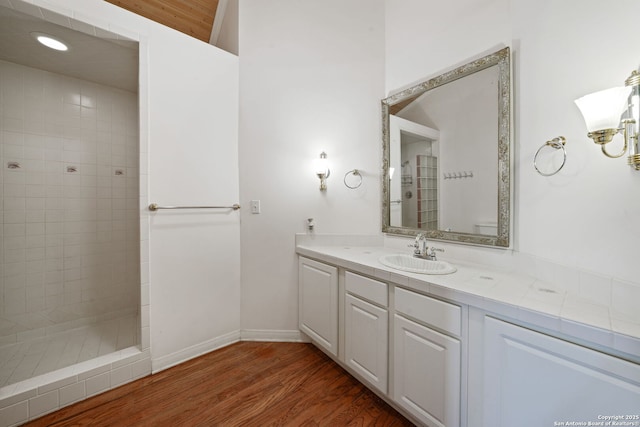 388 Oak, Pipe Creek, TX 78063 - bathroom with walk in shower, wood finished floors, vanity, and baseboards