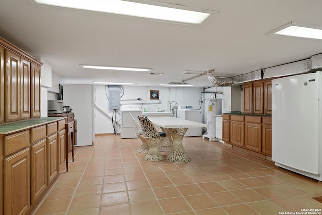388 Oak, Pipe Creek, TX 78063 - kitchen featuring freestanding refrigerator, washer and dryer, electric water heater, electric panel, and light tile patterned flooring